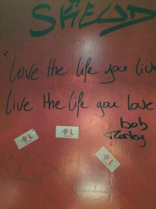 Drunk words on the bathroom wall in the bar